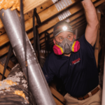 Trutech professional inspecting an attic