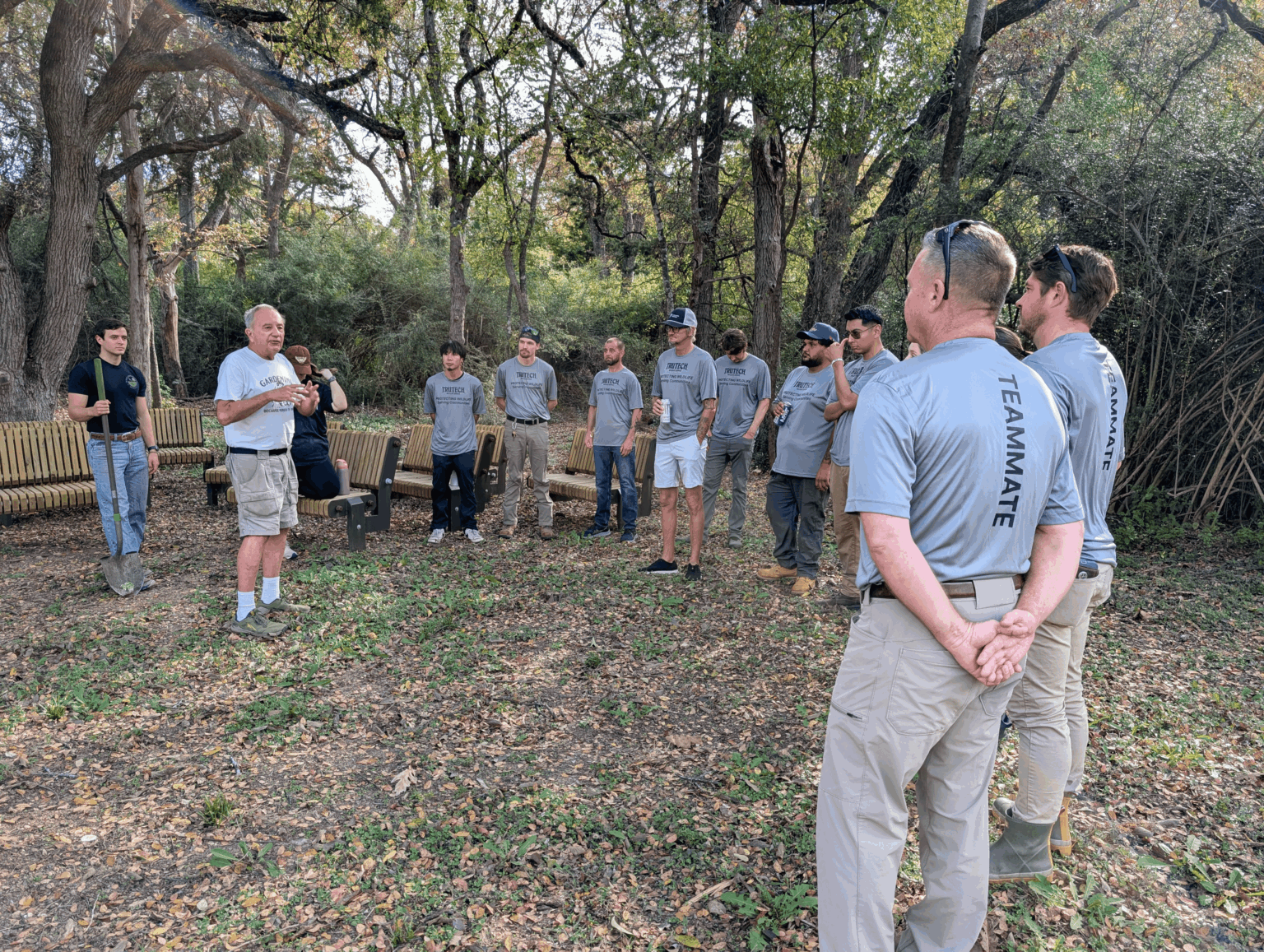 Group of teammates gathered around in a circle Kiest Park